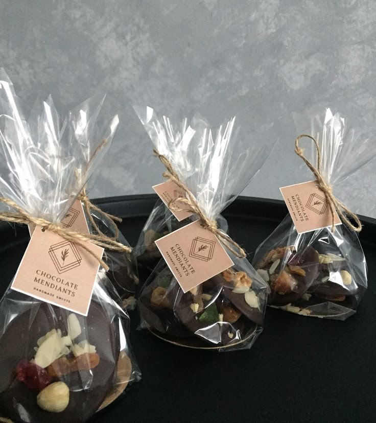 Handmade chocolate mendiants in clear bags with labels, perfect for gifts or events.