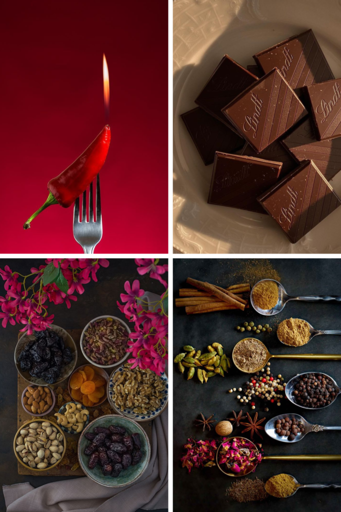 Variety of spices, nuts, and chocolates; a spicy red chili on a fork with flame. Perfect for culinary inspiration.