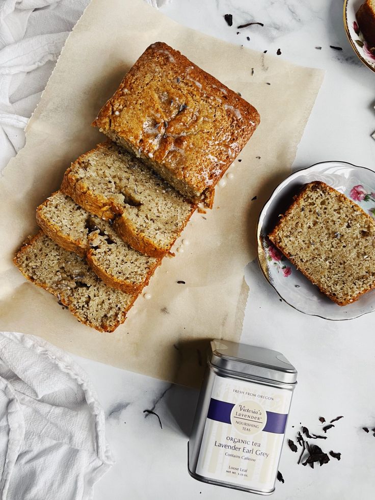 Sliced banana bread with lavender Earl Grey tea on a marble table, ready for a cozy afternoon snack.