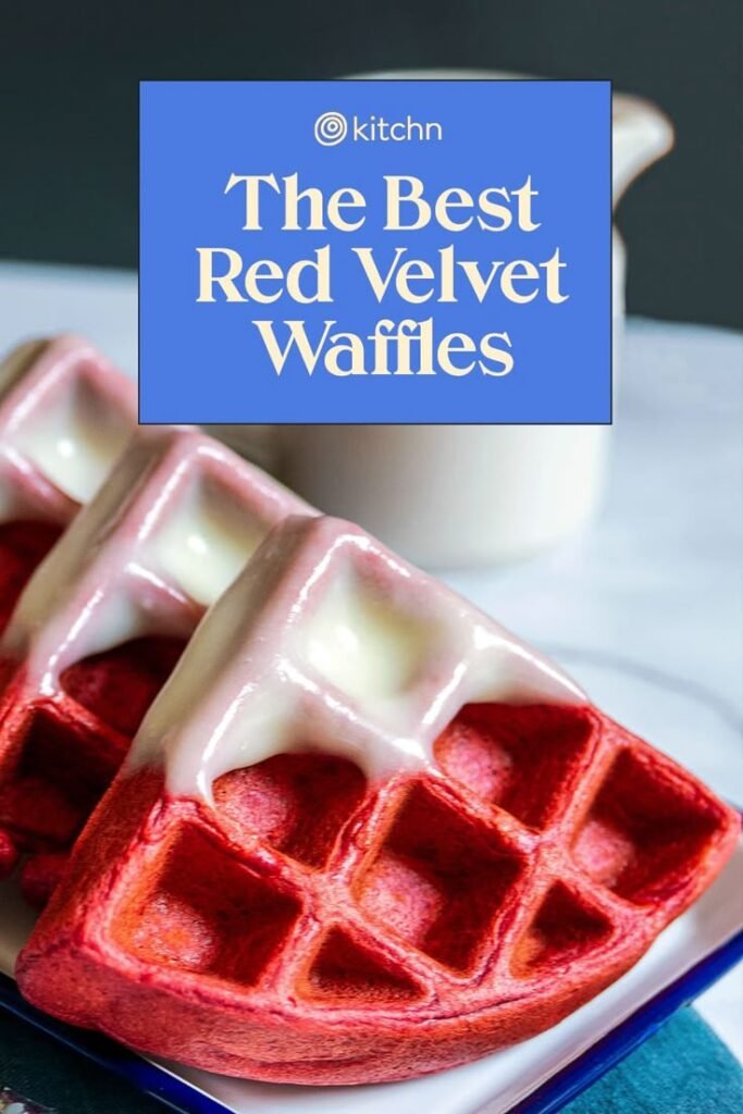 Red velvet waffles with icing on a blue plate, featuring text “The Best Red Velvet Waffles” by Kitchn.