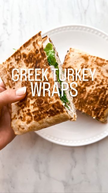 Delicious Greek turkey wraps on a white plate, with a crispy finish and fresh ingredients.
