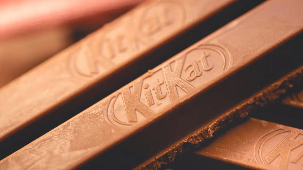 Close-up of chocolate bars with branded logo on a blurred background.
