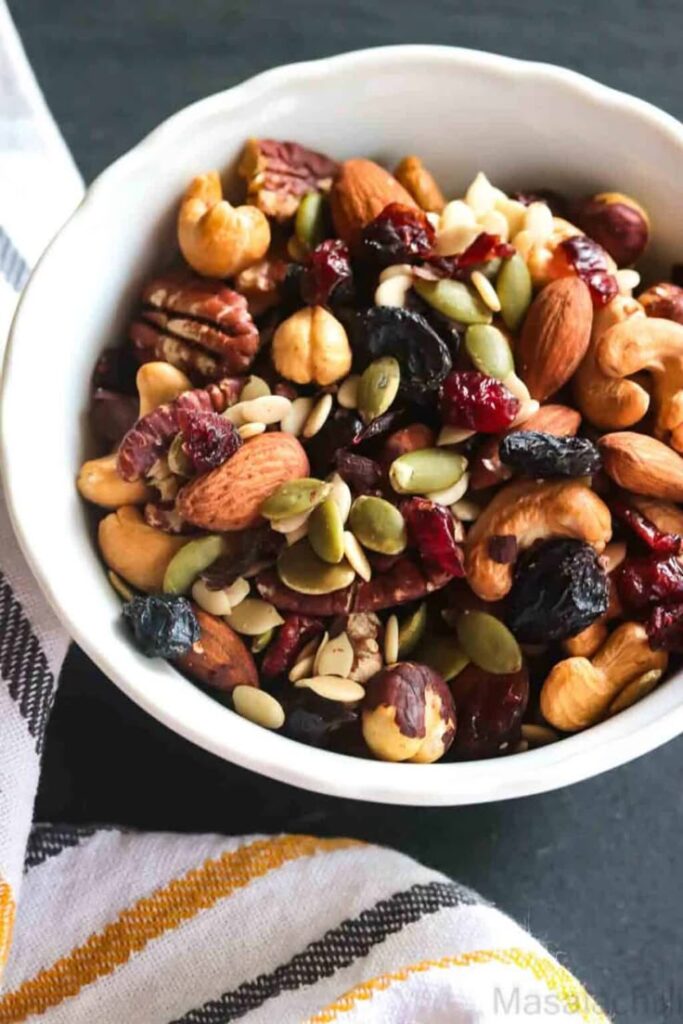 Bowl of mixed nuts and dried fruits for a healthy snack option.