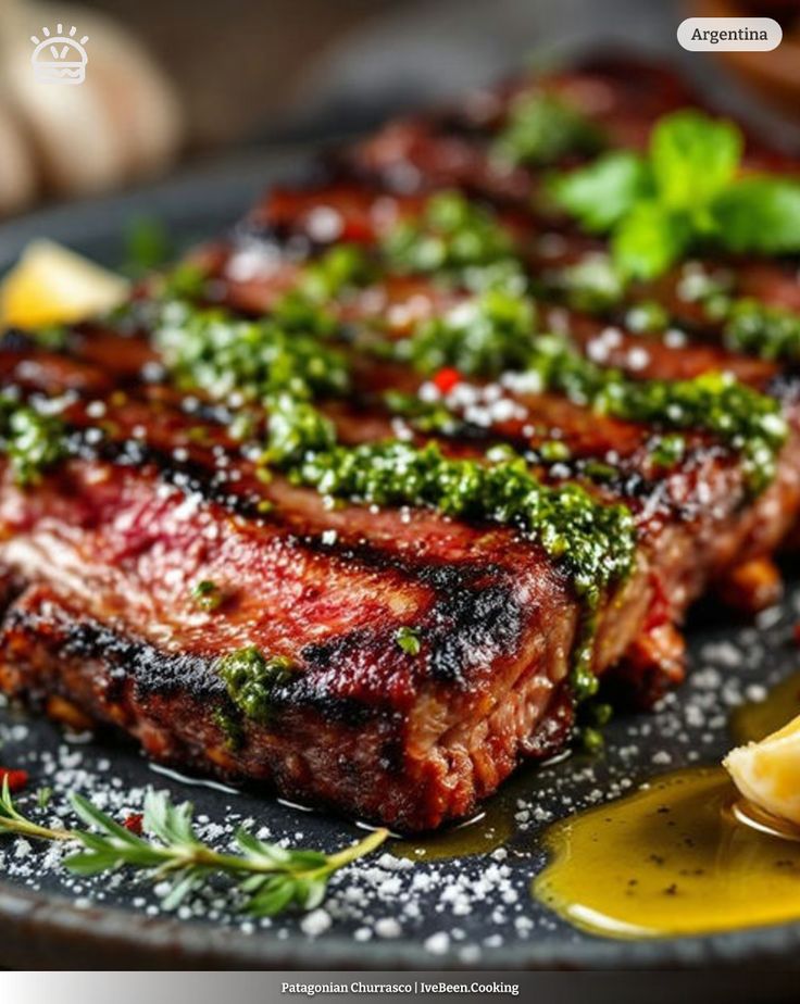 Grilled Patagonia churrasco steak with chimichurri sauce, garnished with herbs on a black plate, Argentina cuisine.