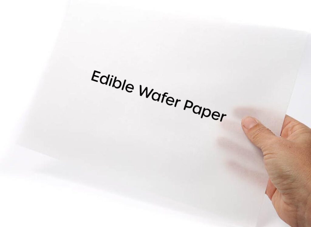Hand holding a sheet of edible wafer paper for baking and cake decoration.