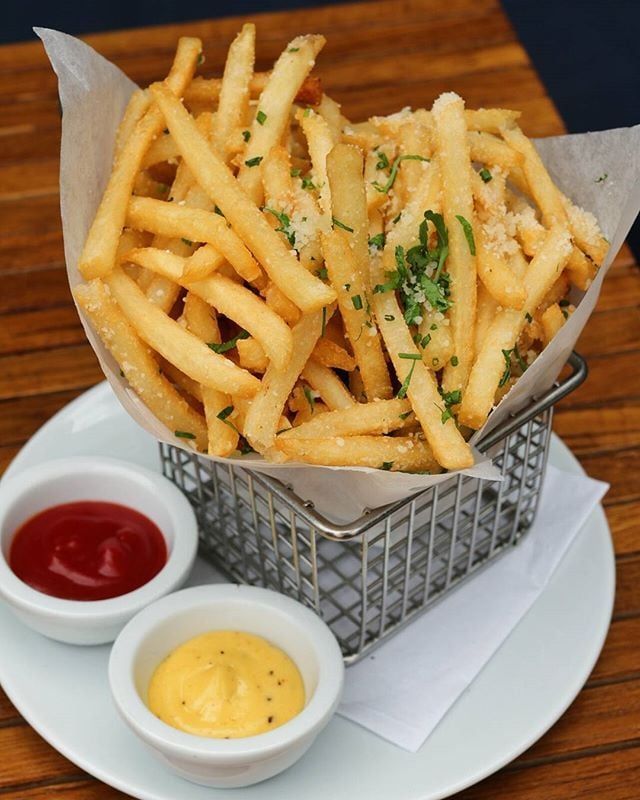 Crispy French fries topped with herbs and Parmesan, served with ketchup and mustard dips.