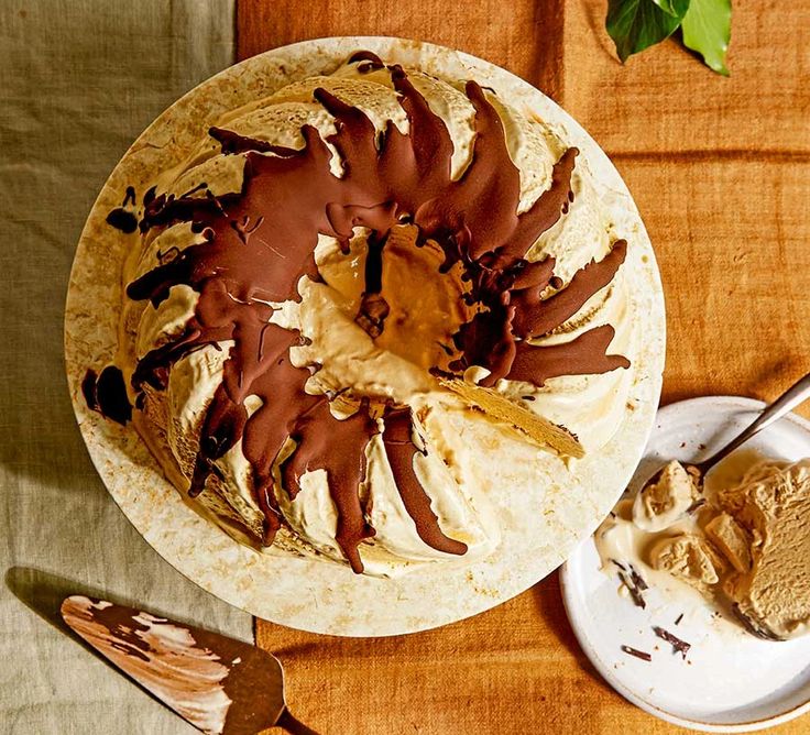 Bundt cake with chocolate glaze on a marble plate, served with a wooden backdrop for a rustic dessert presentation.