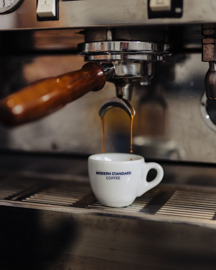 Espresso machine brewing coffee into a Modern Standard mug.