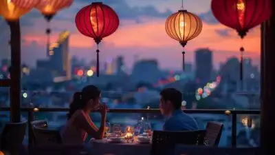Romantic dinner on rooftop with lanterns and city skyline at sunset.