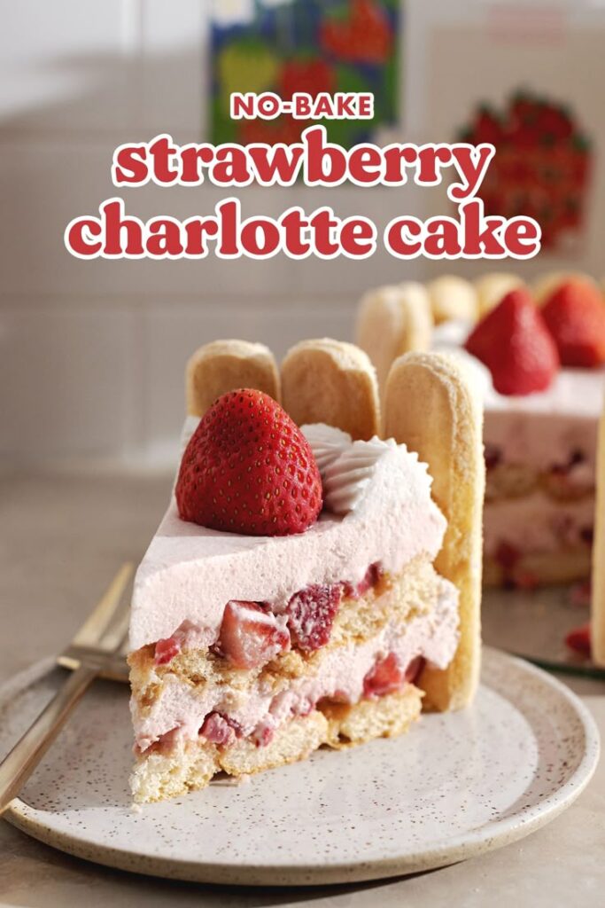 No-bake strawberry Charlotte cake slice with fresh strawberries and ladyfingers, served on a plate.