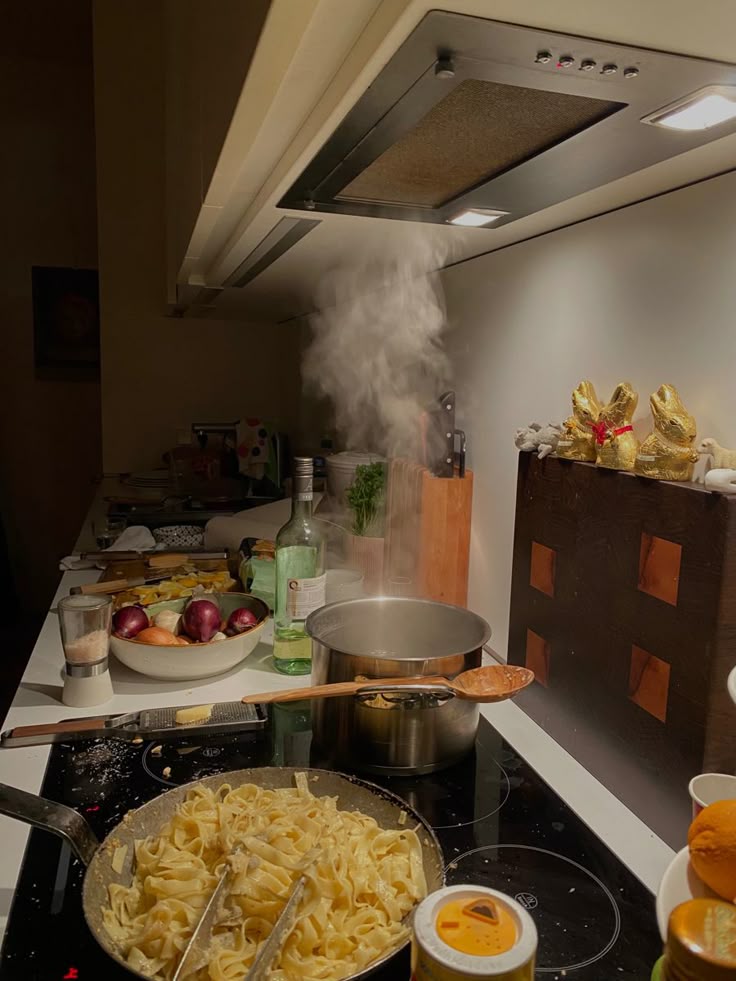 Cooking pasta in a kitchen with steam rising from a pot, surrounded by ingredients and cooking tools.