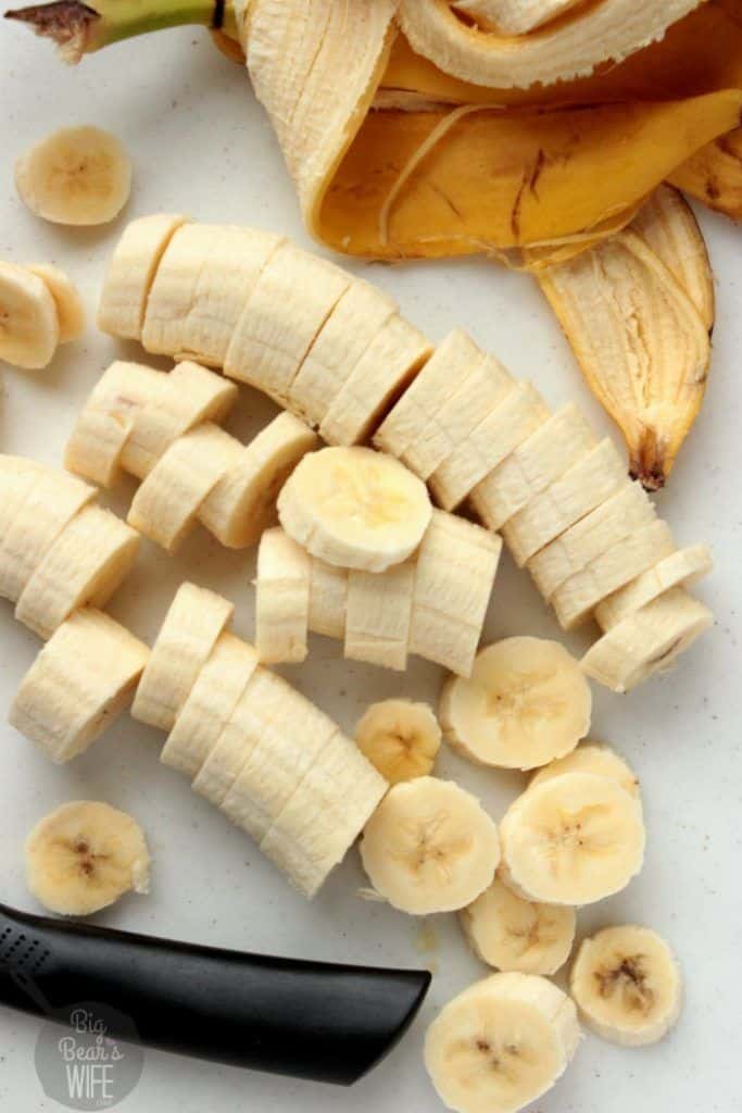 Sliced banana with peel on a cutting board, ready for snack or recipe preparation.