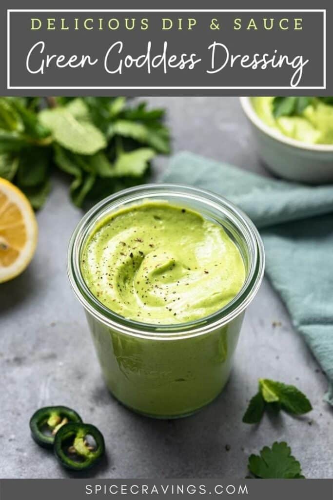 Green Goddess dressing in a jar, garnished with herbs and lemon, ideal as a delicious dip or sauce.