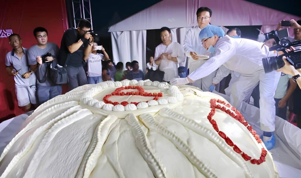 Scientists examine massive dumpling while onlookers photograph the event at a food festival.