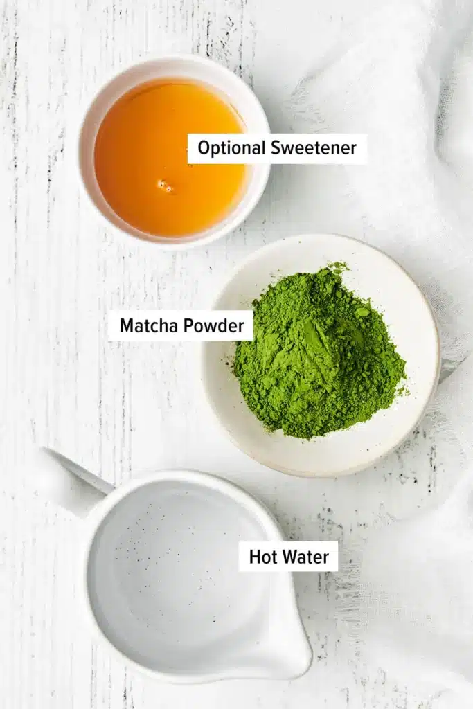 Matcha green tea ingredients: matcha powder, hot water, and optional sweetener on a white background.