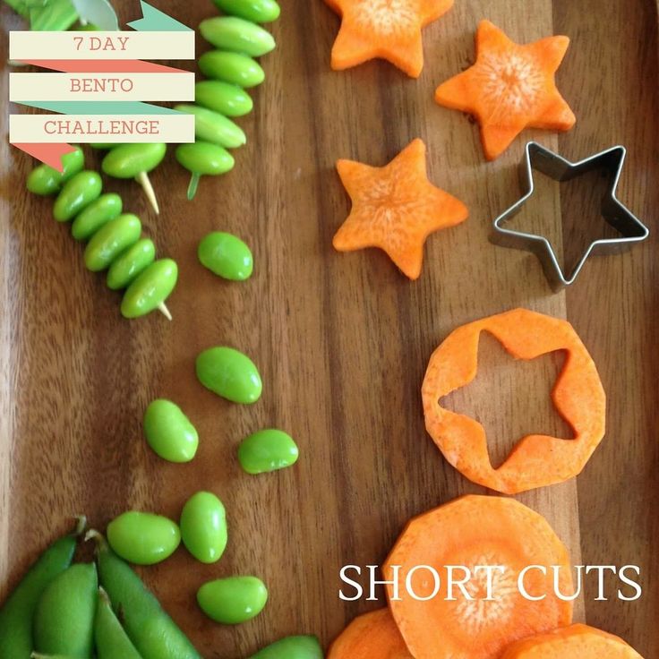 Star-shaped carrot cuts and edamame on a wooden board for a bento box challenge.