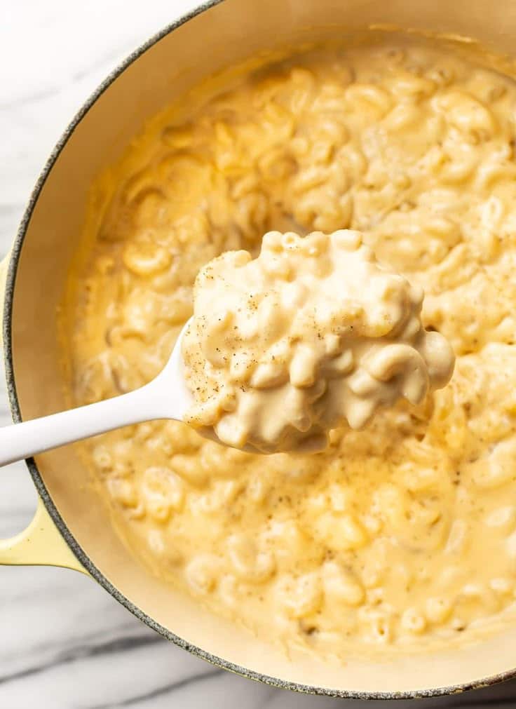 Creamy homemade mac and cheese in a pot with a spoon, ready to serve. Comfort food perfection.