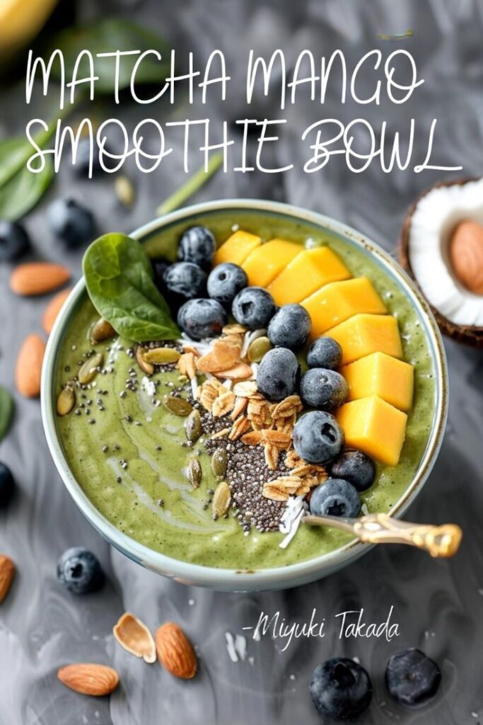 Matcha mango smoothie bowl topped with blueberries, chia seeds, and almonds for a healthy breakfast boost.