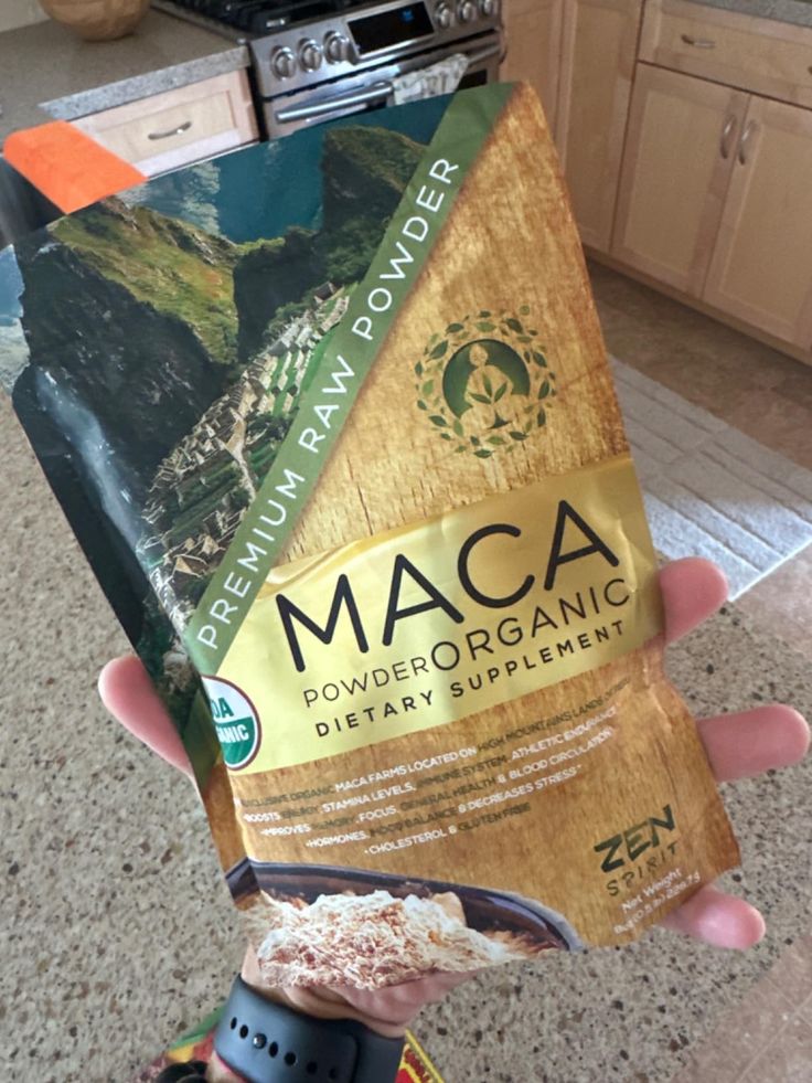Organic Maca Powder Supplement in hand, kitchen background, promoting health benefits. Premium raw superfood packaging.
