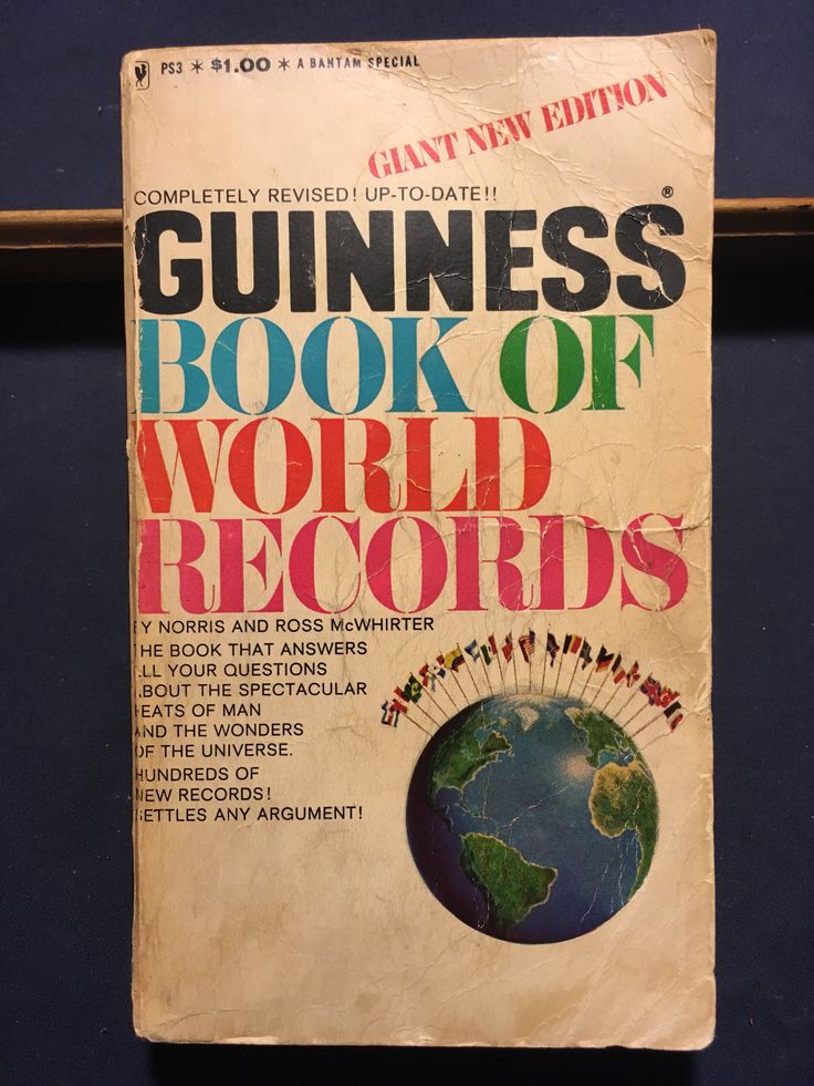 Guinness Book of World Records cover, giant new edition, featuring an image of Earth with flags above it.