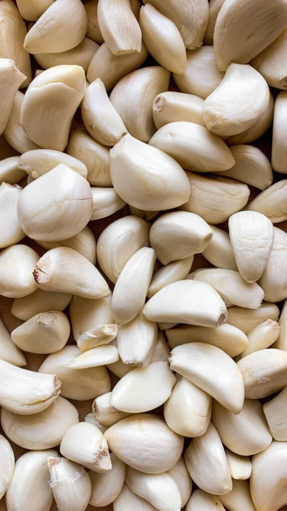 Peeled garlic cloves, close-up view. Perfect for cooking, adding flavor and aroma to various dishes.