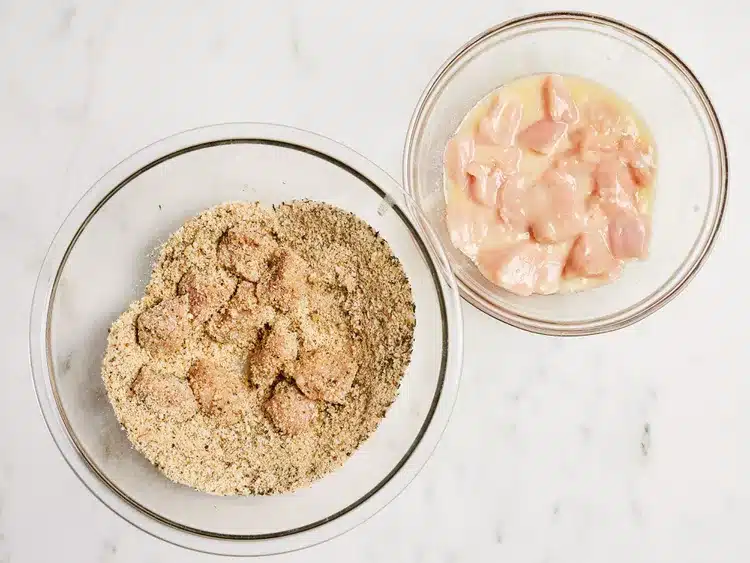 Chicken pieces in egg wash and breadcrumb coating, ready for frying. Perfect for crispy chicken recipes.