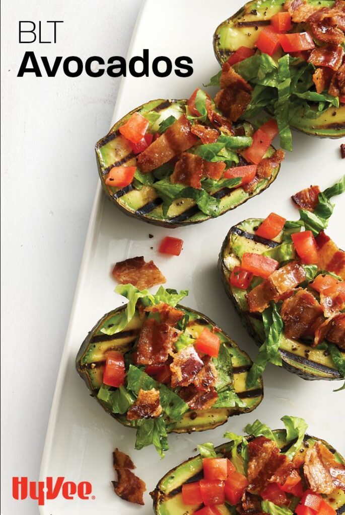 BLT stuffed avocados with bacon, lettuce, and tomato arranged on a white platter from Hy-Vee.