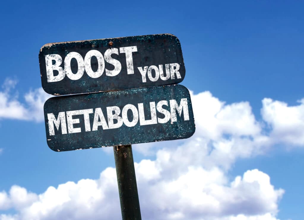 Sign reading Boost Your Metabolism against a cloudy blue sky background, promoting healthy lifestyle choices.