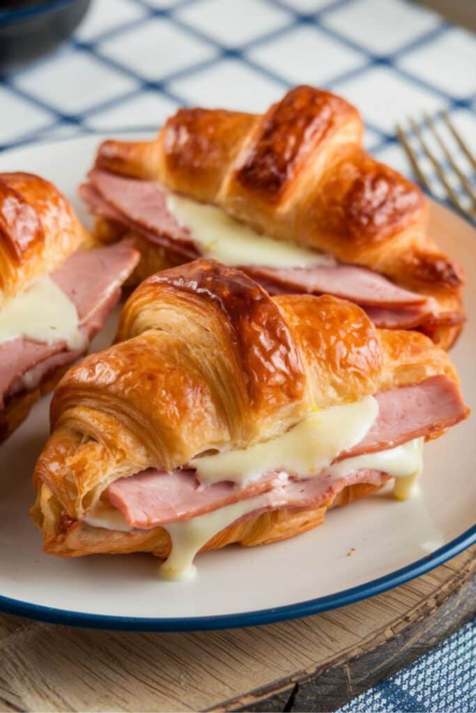 Delicious ham and cheese croissants on a plate, perfect for breakfast or brunch.