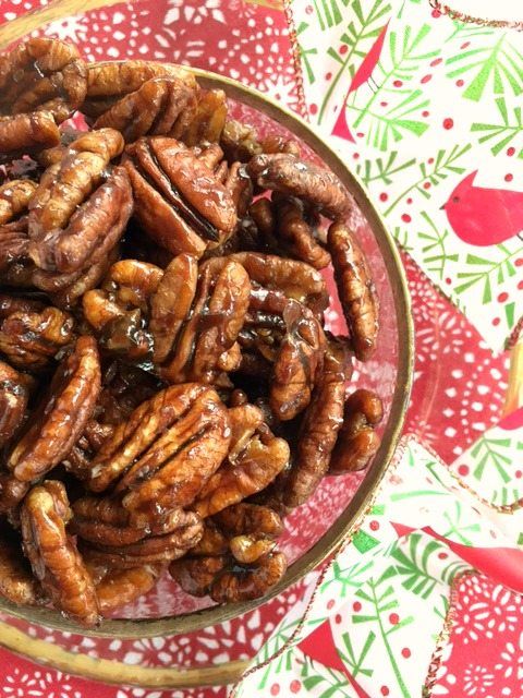 Toasted pecans in a festive bowl, perfect for Christmas snacking or gifting.