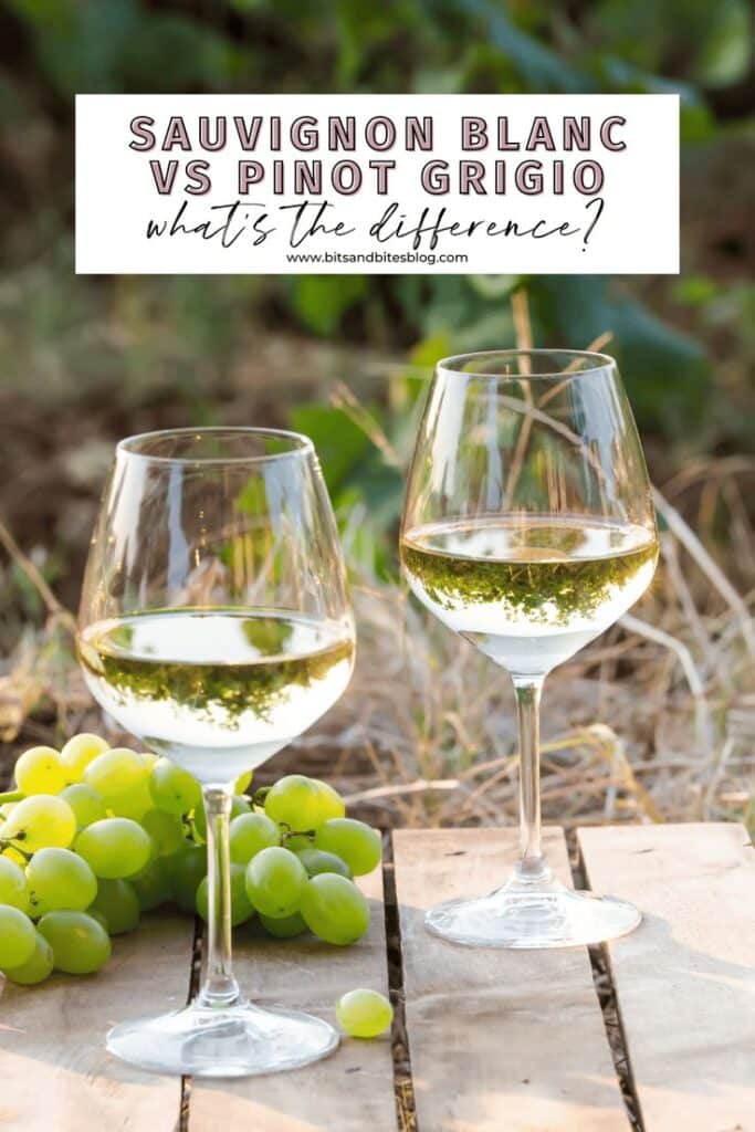 Two wine glasses filled with white wine on a wooden table, surrounded by green grapes in a vineyard setting.