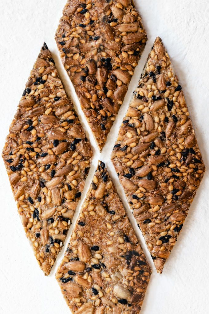 Diamond-shaped seed and nut bars on a white background, showcasing a healthy snack option.