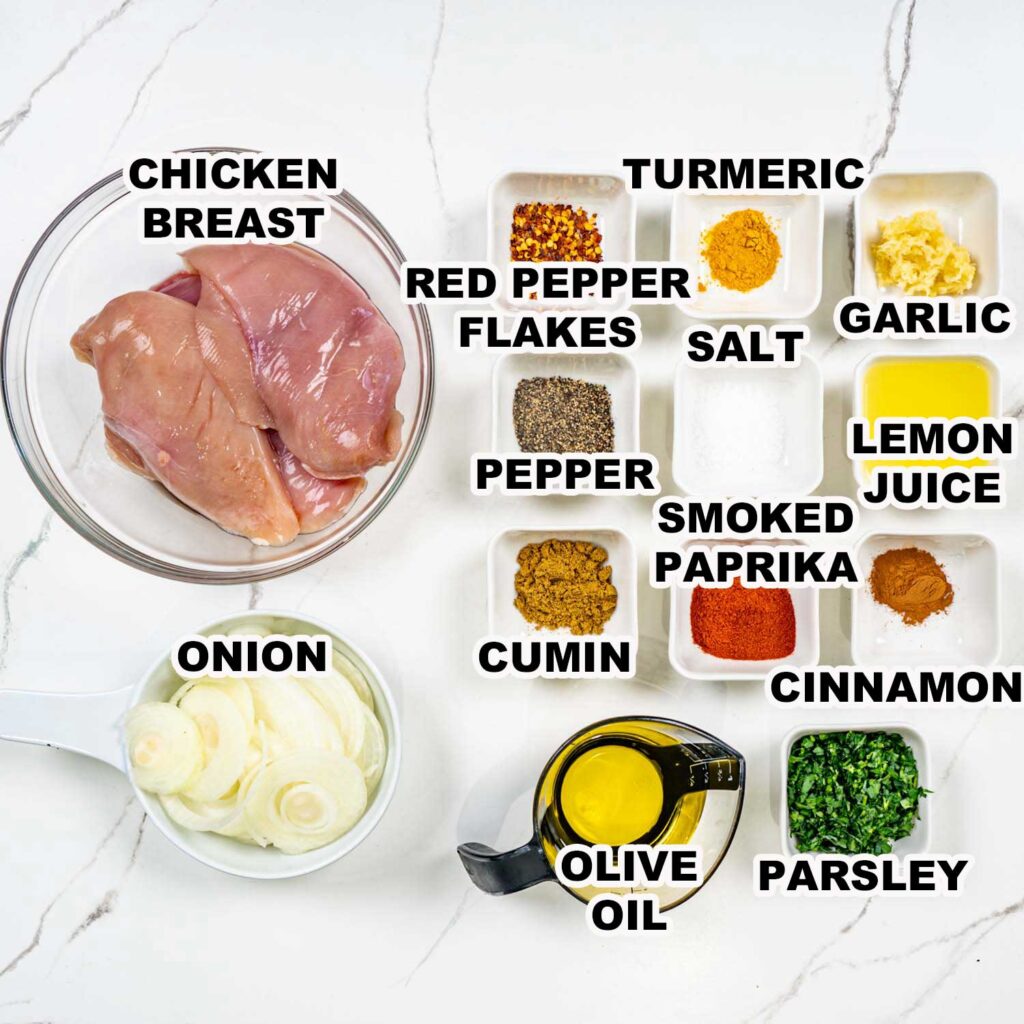 Ingredients for grilled chicken: chicken breast, onion, spices (red pepper, turmeric, garlic, salt), olive oil, parsley.