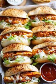 Delicious chicken sandwiches with lettuce and sauce, perfect for a tasty meal or snack.