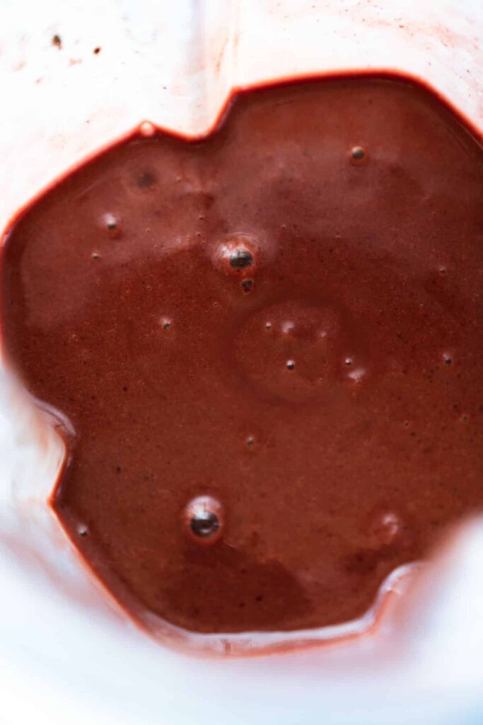 Close-up of smooth chocolate batter in a blender, perfect for baking or desserts.