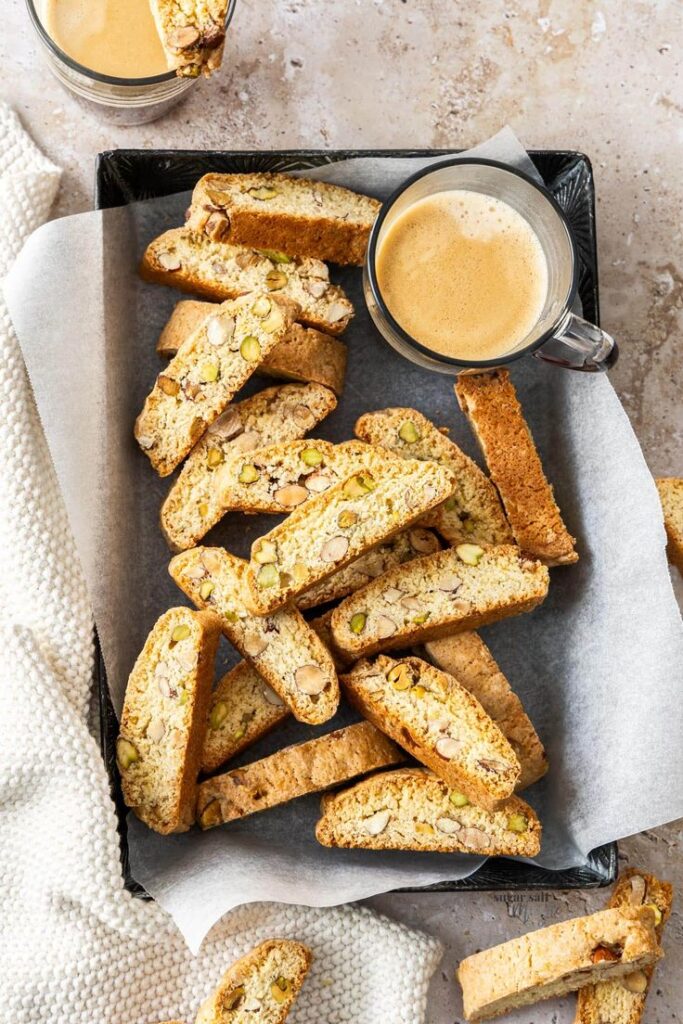 Biscotti cookies with nuts and coffee on a tray, perfect for a cozy breakfast or snack time.