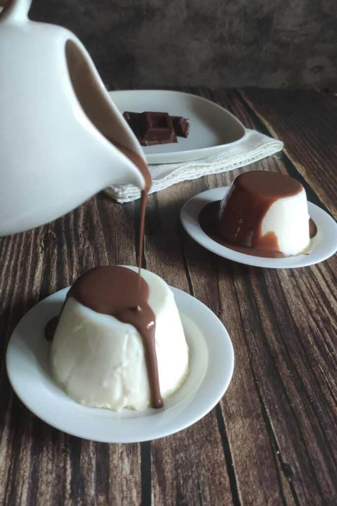 Creamy dessert topped with rich chocolate sauce on rustic table. Indulgent, sweet delight for chocolate lovers.