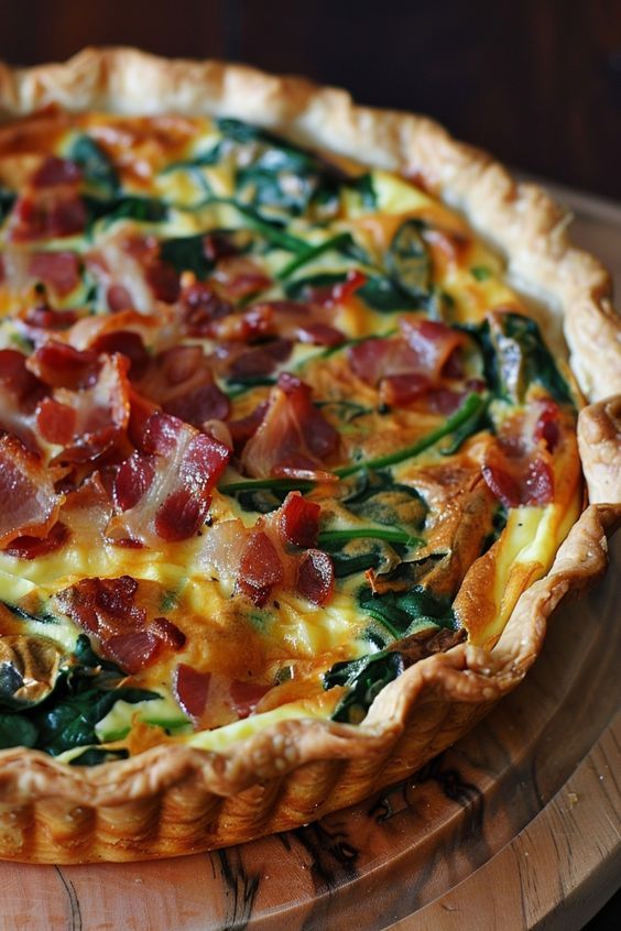 Delicious bacon and spinach quiche with golden crust, perfect for brunch or a savory breakfast.