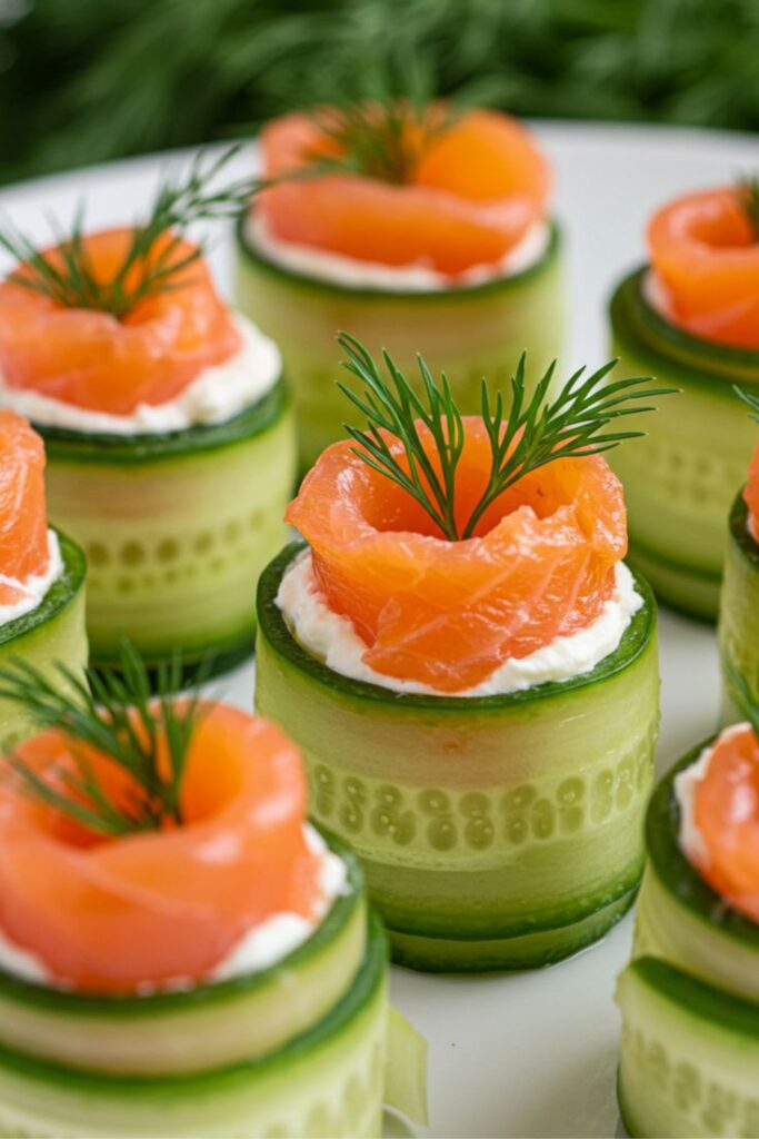 Easy Smoked Salmon Cucumber Rolls Recipe - 10 Crowd-Pleasing Appetizers That Will Wow Your Party | Elegant cucumber rolls topped with smoked salmon, cream cheese, and dill sprigs on a light background.