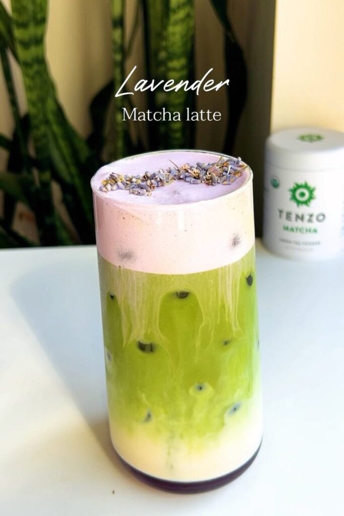 Lavender matcha latte with pastel colors and lavender sprigs, Tenzo matcha canister in the background.