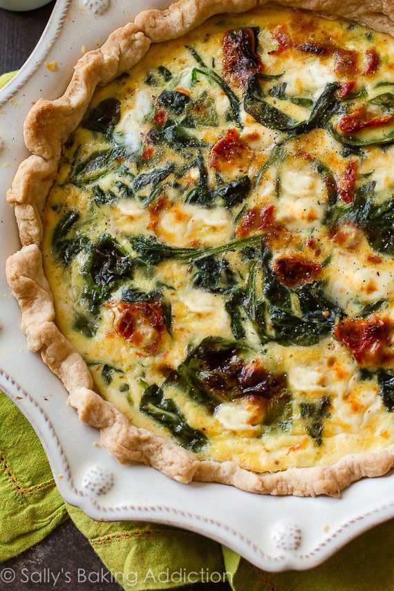Delicious spinach and sun-dried tomato quiche in a flaky pie crust, perfect for brunch or a savory meal.
