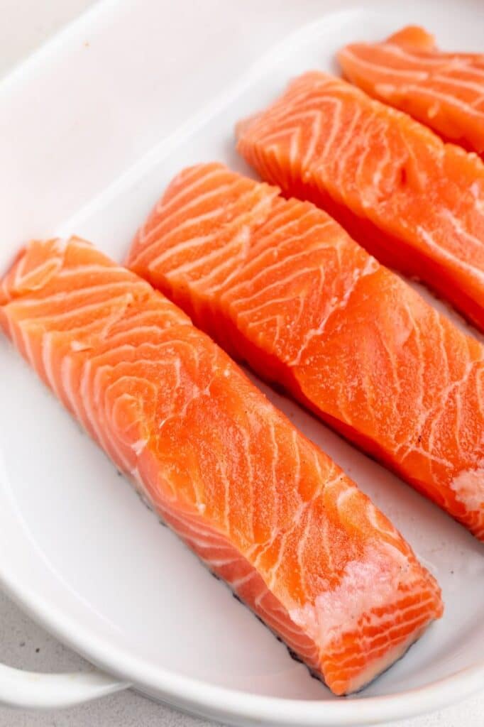 Fresh salmon fillets in a white dish, perfect for nutritious seafood recipes.