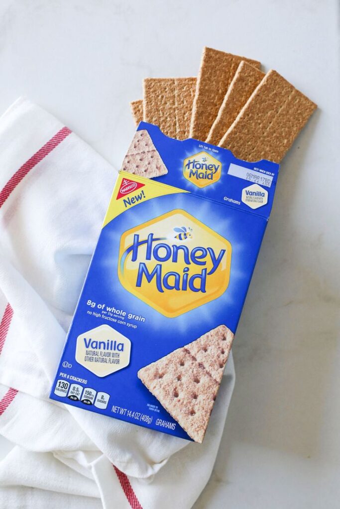 Box of Honey Maid vanilla graham crackers on a white and red cloth.