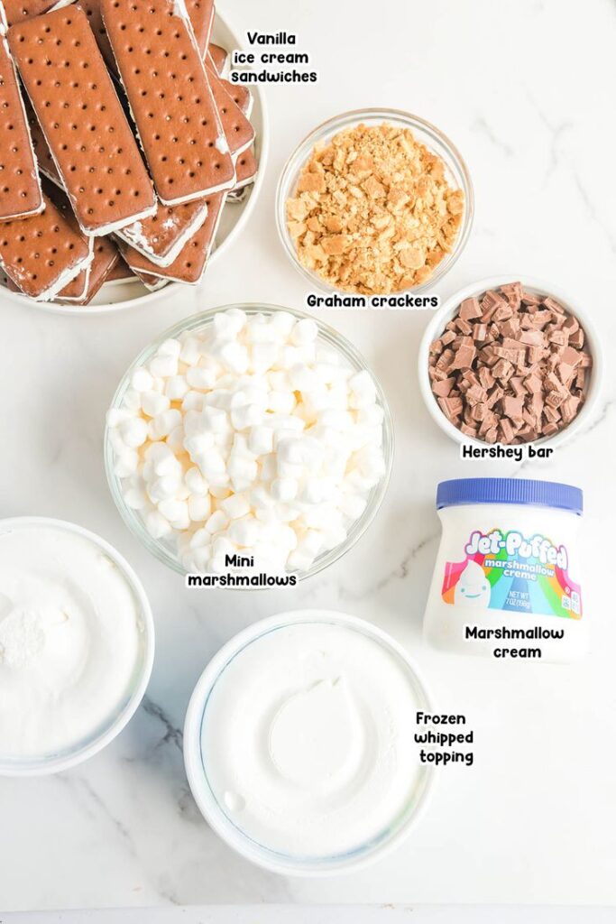 Ingredients for a sweet treat: ice cream sandwiches, crushed graham crackers, Hershey's, marshmallows, whipped topping.