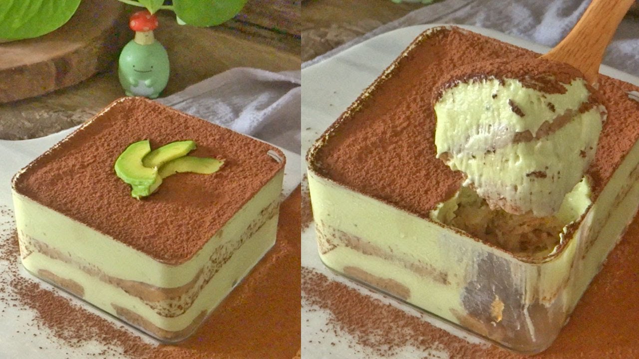Creamy avocado tiramisu topped with cocoa powder and avocado slices in a glass dish. Perfect dessert creation.