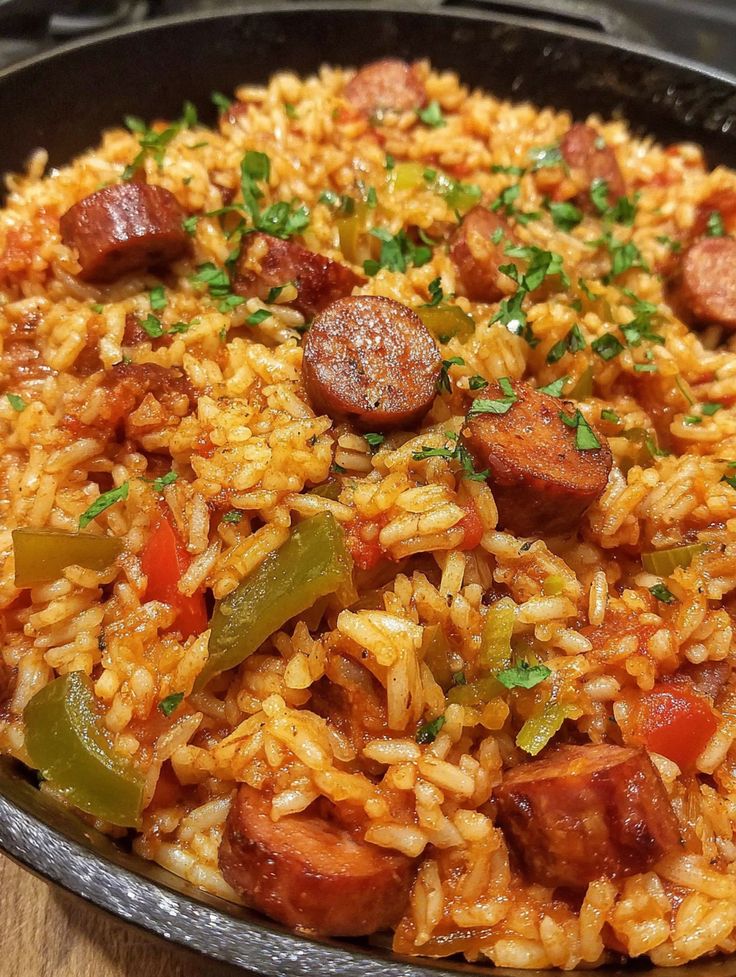 Cajun Sausage Rice - Tylas Recipes - One-Pan Spanish Style Meat and Tomato Rice: Your New Weeknight Hero! | Hearty Cajun jambalaya with sausage, bell peppers, and rice in a skillet, garnished with fresh parsley.