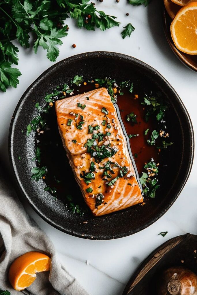 Chinese Beef and Onion Stir-Fry - Festive Cranberry-Orange Glazed Salmon Recipe| Grilled salmon with herbs and sauce in a black skillet, garnished with fresh parsley and orange slices.