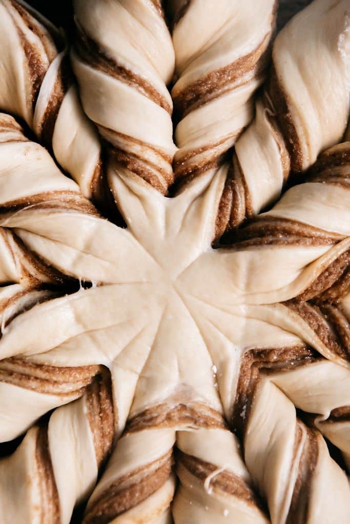 Cinnamon Sugar Star Bread - Heathers Home Bakery - Bake Some Magic! Festive Christmas Star Cinnamon Rolls | Intricate braided dough design with swirled cinnamon, ready for baking. Unique pastry pattern for delicious treats.