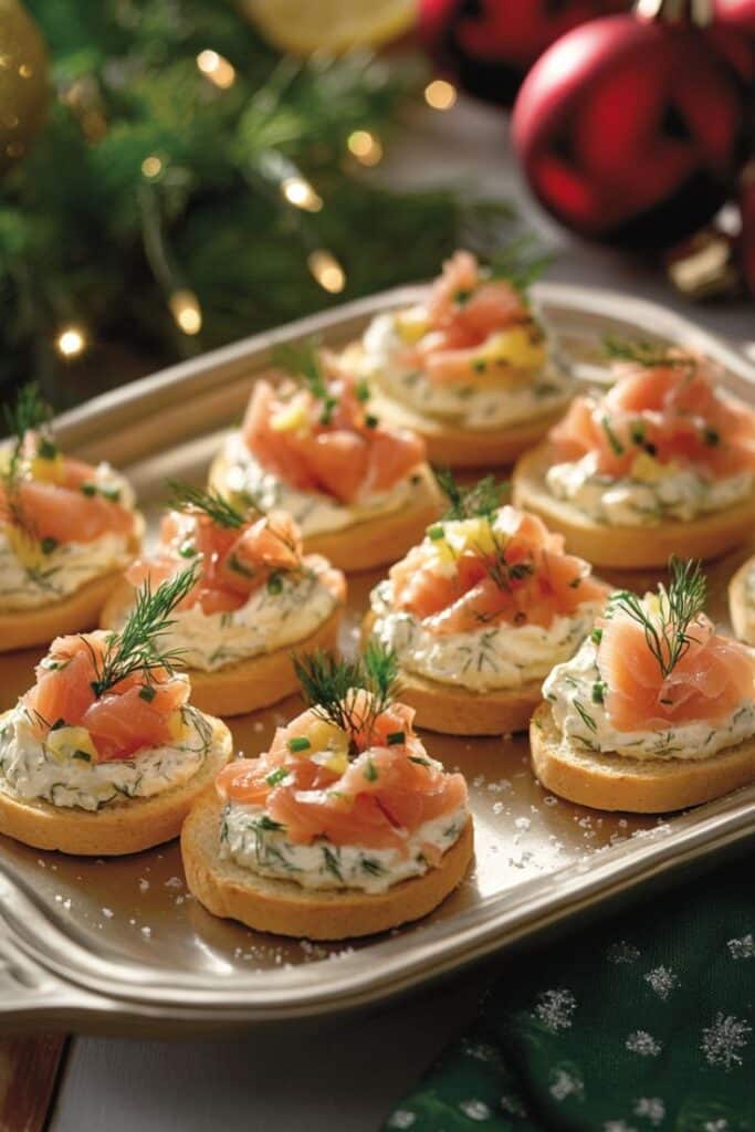 Festive smoked salmon canapés with cream cheese and dill on a platter, perfect for holiday gatherings.