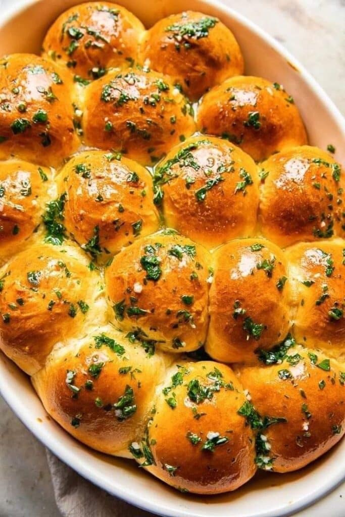 undefined 4 - Garlic Parmesan Pull-Apart Rolls Recipe Golden garlic and herb pull-apart rolls in a baking dish, perfect for a savory appetizer or side dish.
